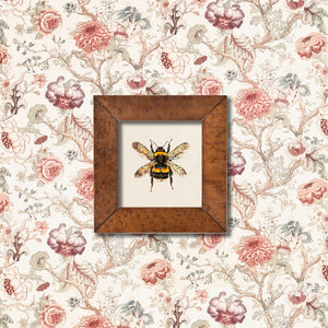 Lottie Pratt bumblebee greeting card displayed in a frame against botanical fabric